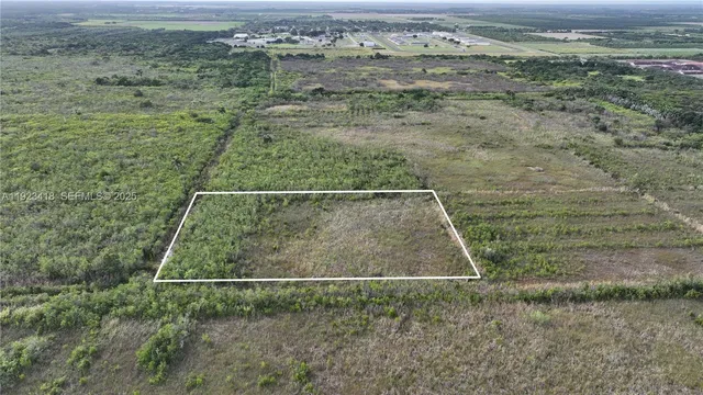 a view of a field with an ocean view