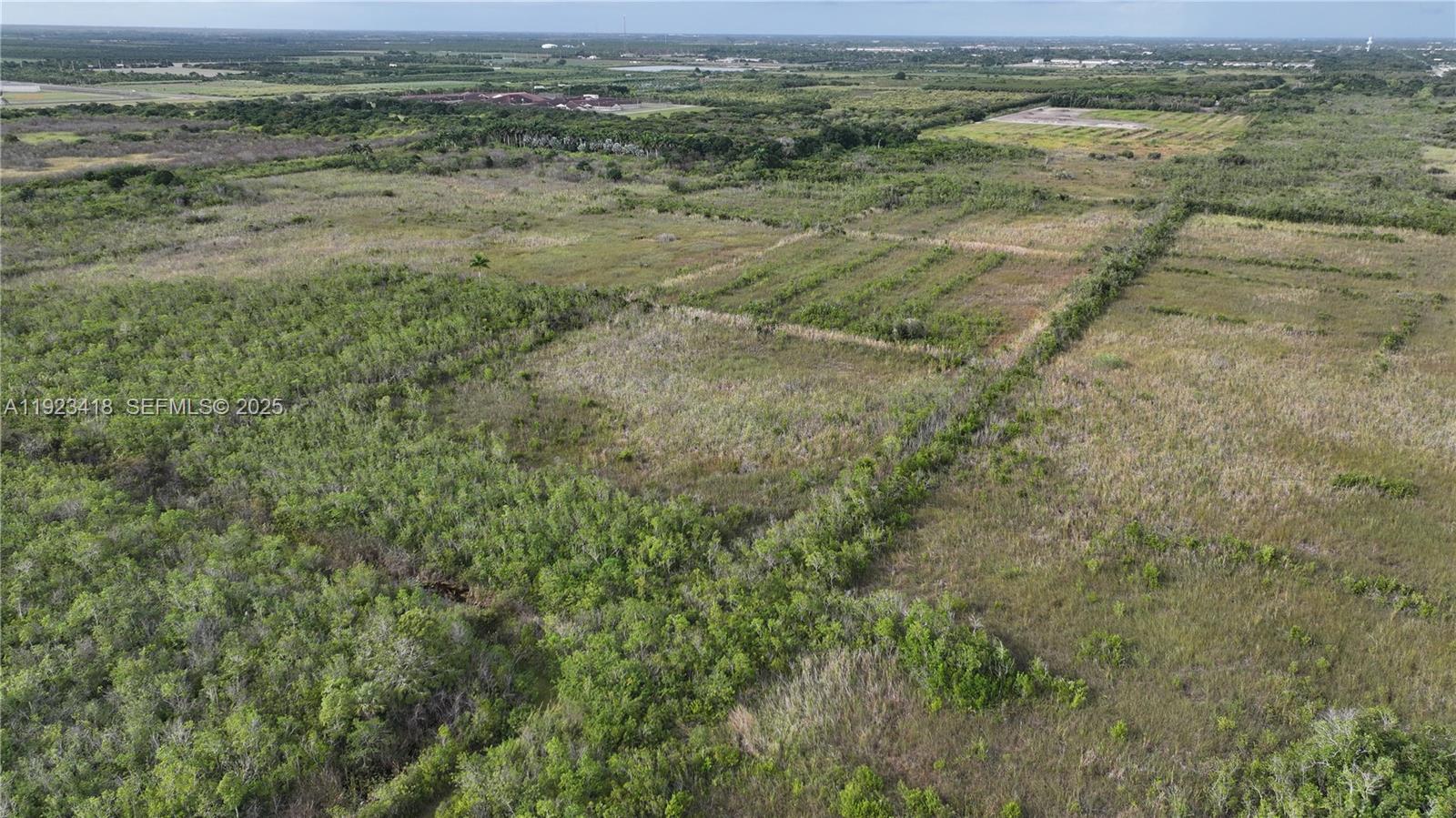 0 Southwest 382nd Street Homestead, FL 33034 - Photo 14 of 27 a view of a field with trees in the background