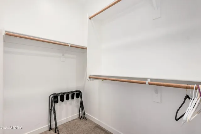 a view of walk in closet with empty racks