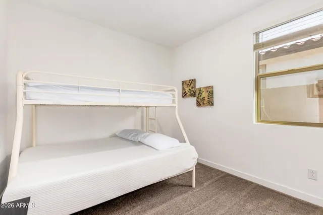 a bedroom with a bed and window