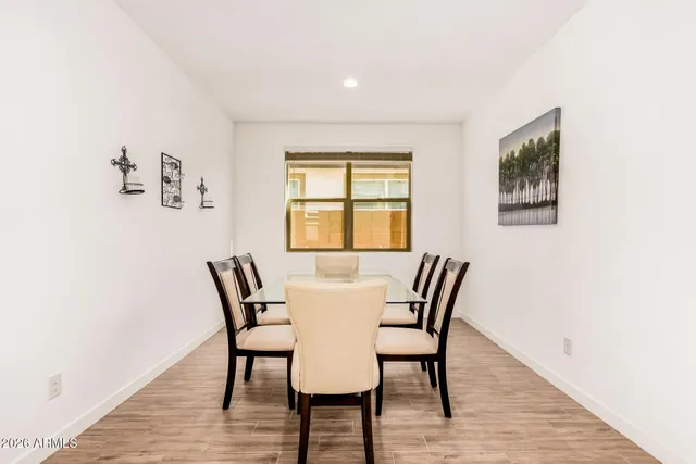 a view of a dining room with furniture and wooden floor