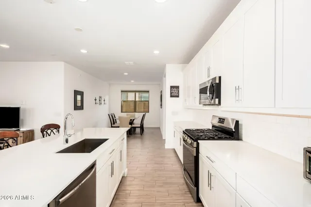 a kitchen with a sink and a stove top oven