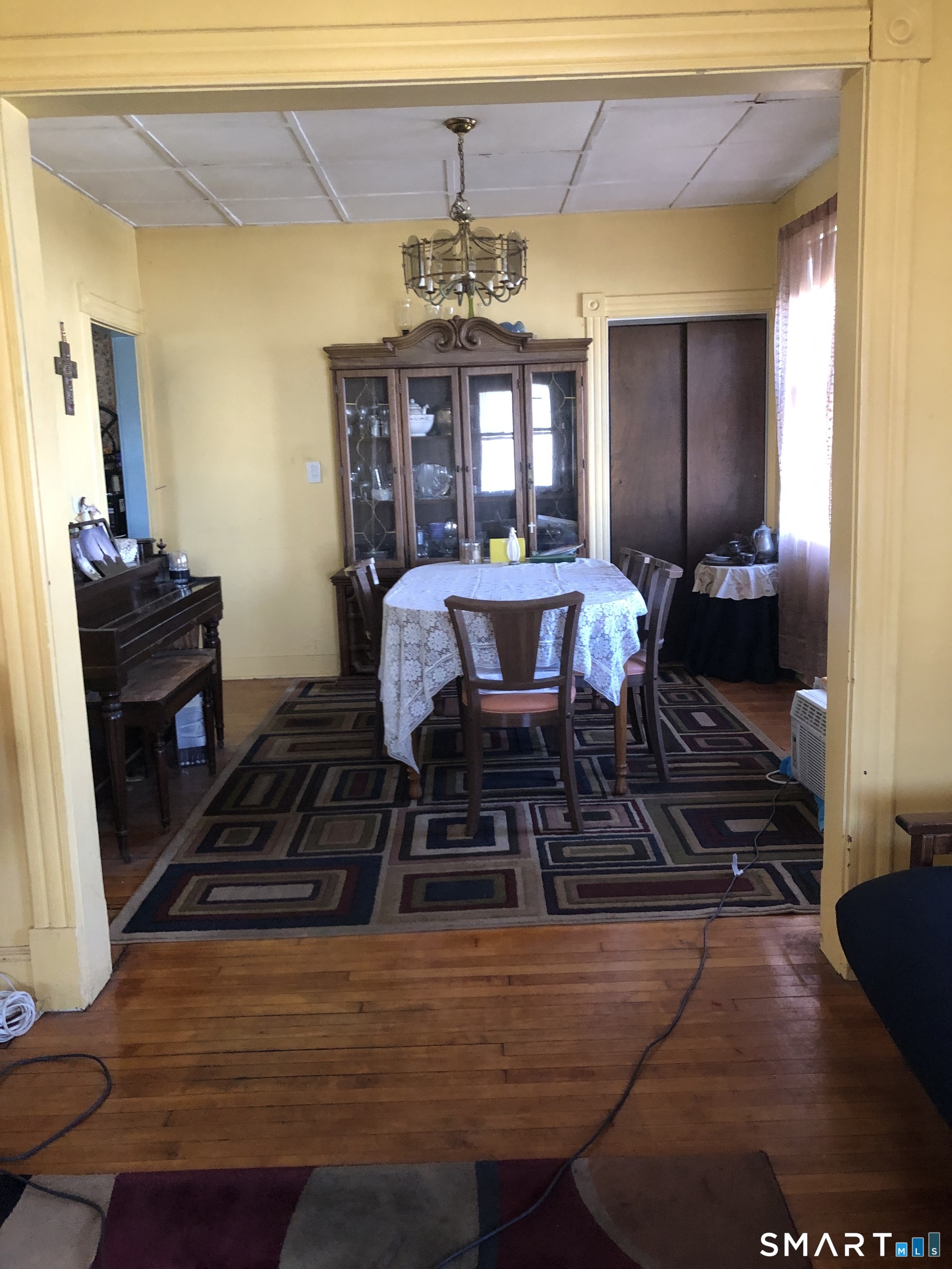 161 Spring Street Meriden, CT 06451 - Photo 17 of 22 a view of a dining room with furniture a chandelier and wooden floor