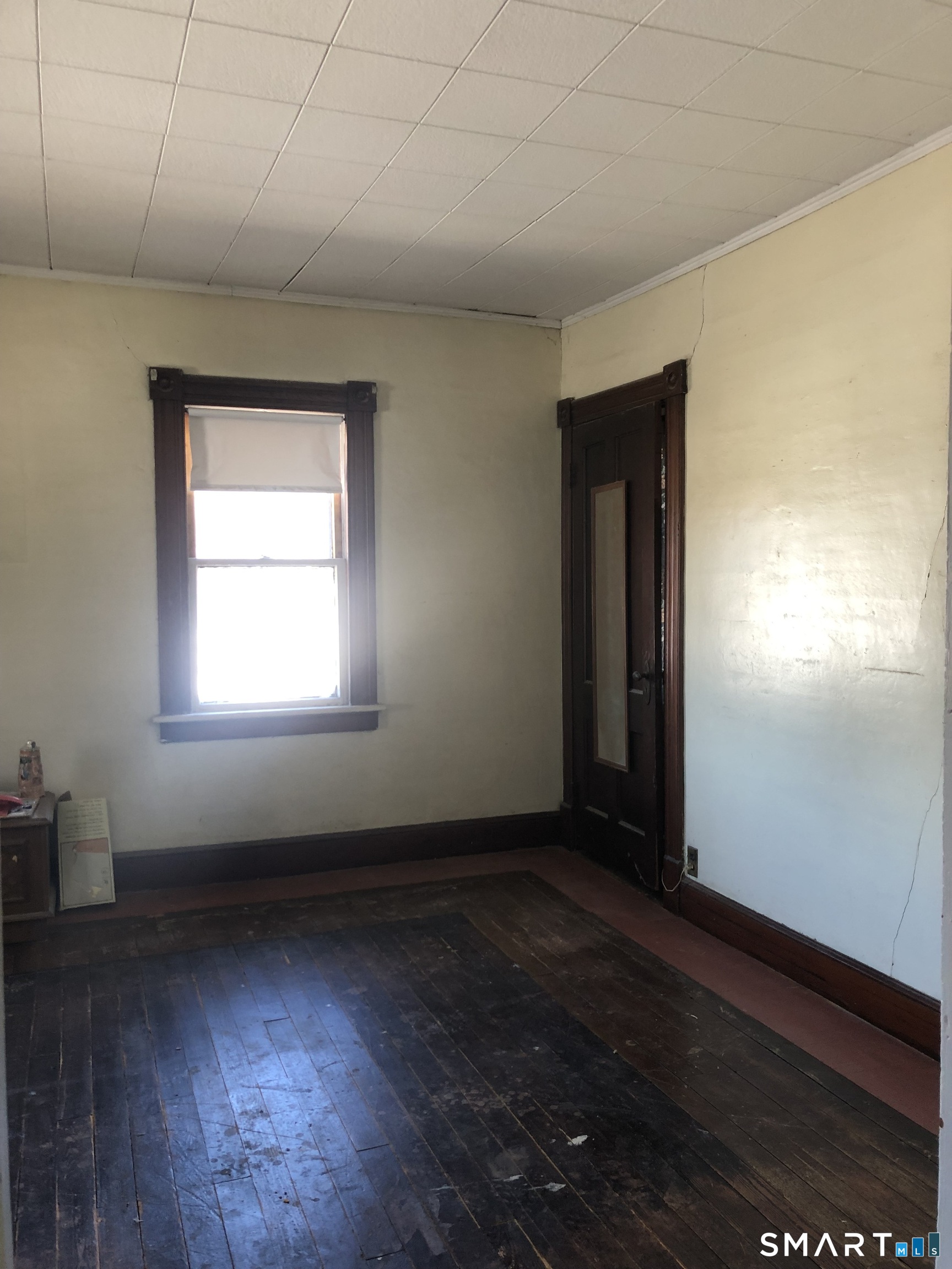 161 Spring Street Meriden, CT 06451 - Photo 18 of 22 an empty room with wooden floor and windows