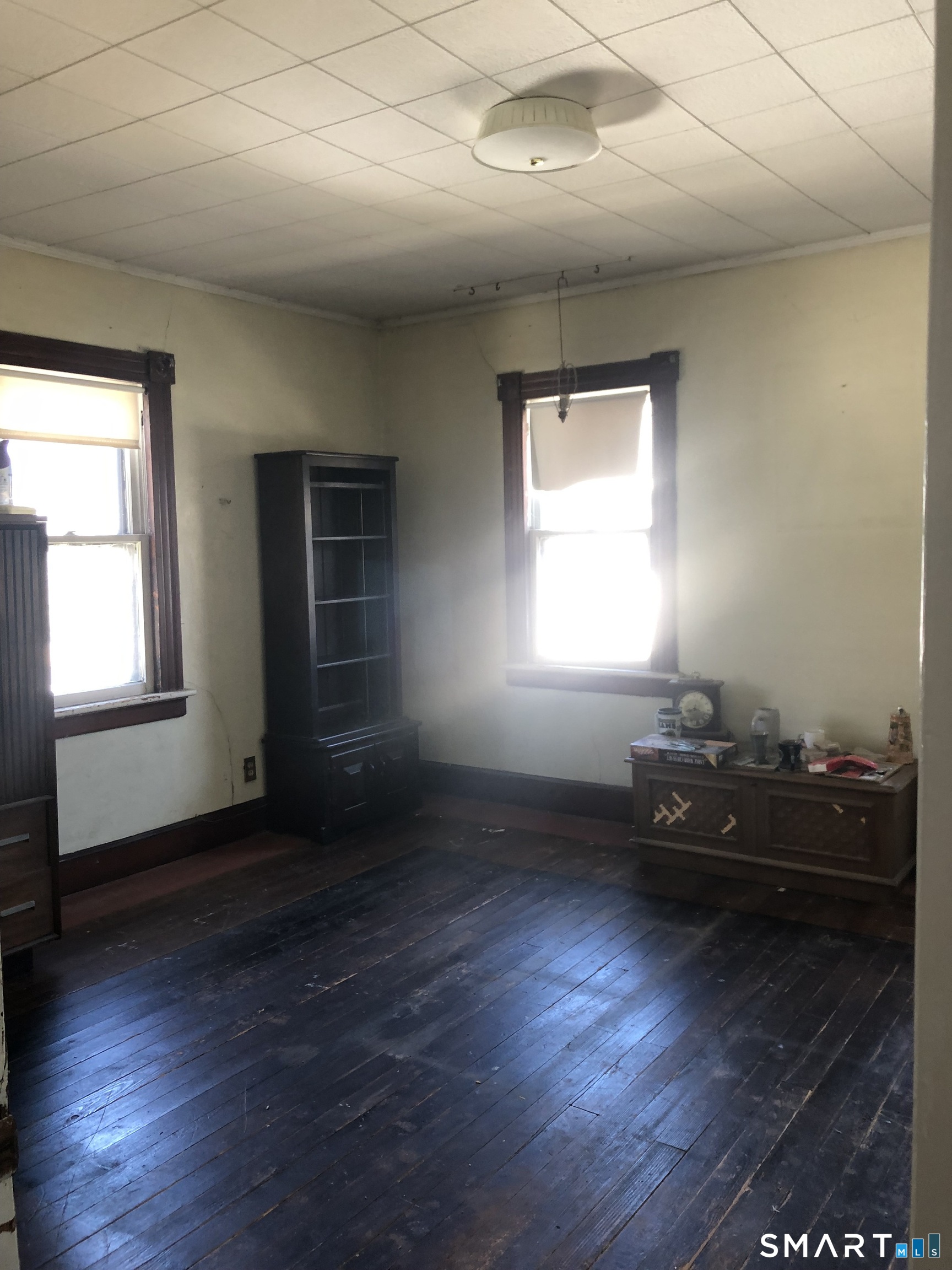 161 Spring Street Meriden, CT 06451 - Photo 19 of 22 an empty room with wooden floor and windows