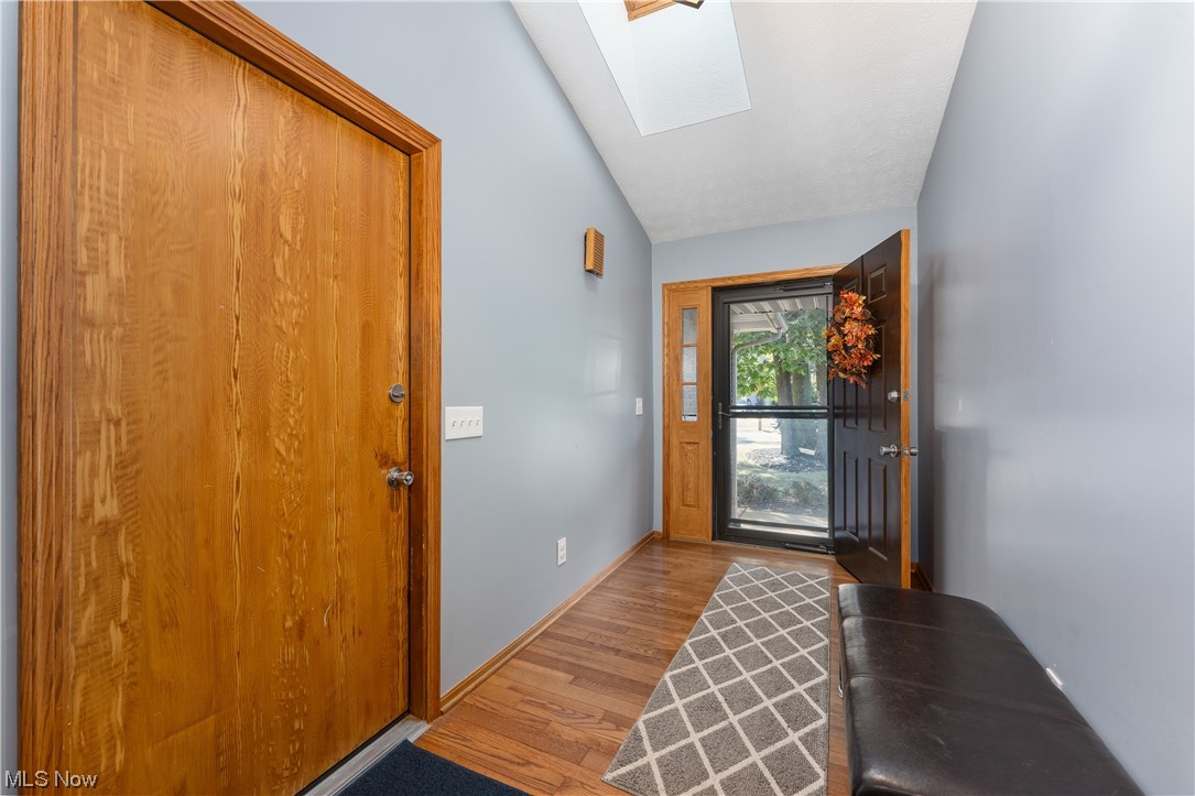 5226 Johnnycake Ridge Northeast Canton, OH 44705 - Photo 10 of 32 Foyer with vaulted ceiling with skylight and light hardwood flooring