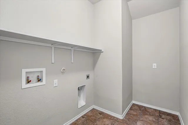 a view of storage and utility room with closet