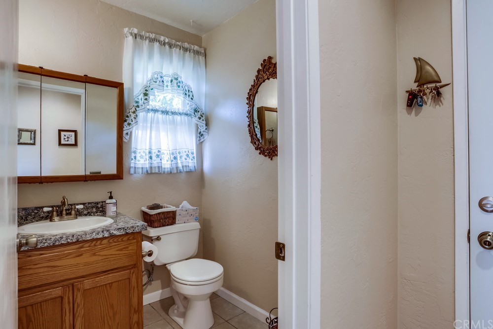 2725 Alta Vista Drive Fallbrook, CA 92028 - Photo 23 of 50 a bathroom with a granite countertop toilet sink and mirror