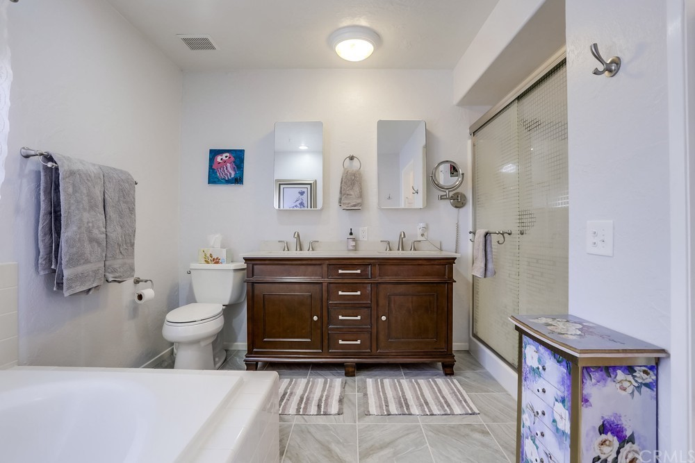 2725 Alta Vista Drive Fallbrook, CA 92028 - Photo 30 of 50 a bathroom with a toilet a sink and mirror