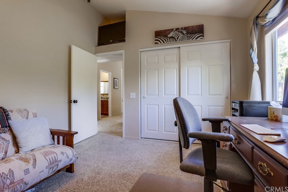 2725 Alta Vista Drive Fallbrook, CA 92028 - Photo 36 of 50 a living room with furniture a window and a flat screen tv