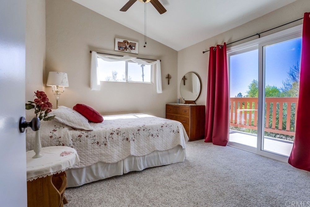 2725 Alta Vista Drive Fallbrook, CA 92028 - Photo 37 of 50 a bedroom with a bed and a chandelier