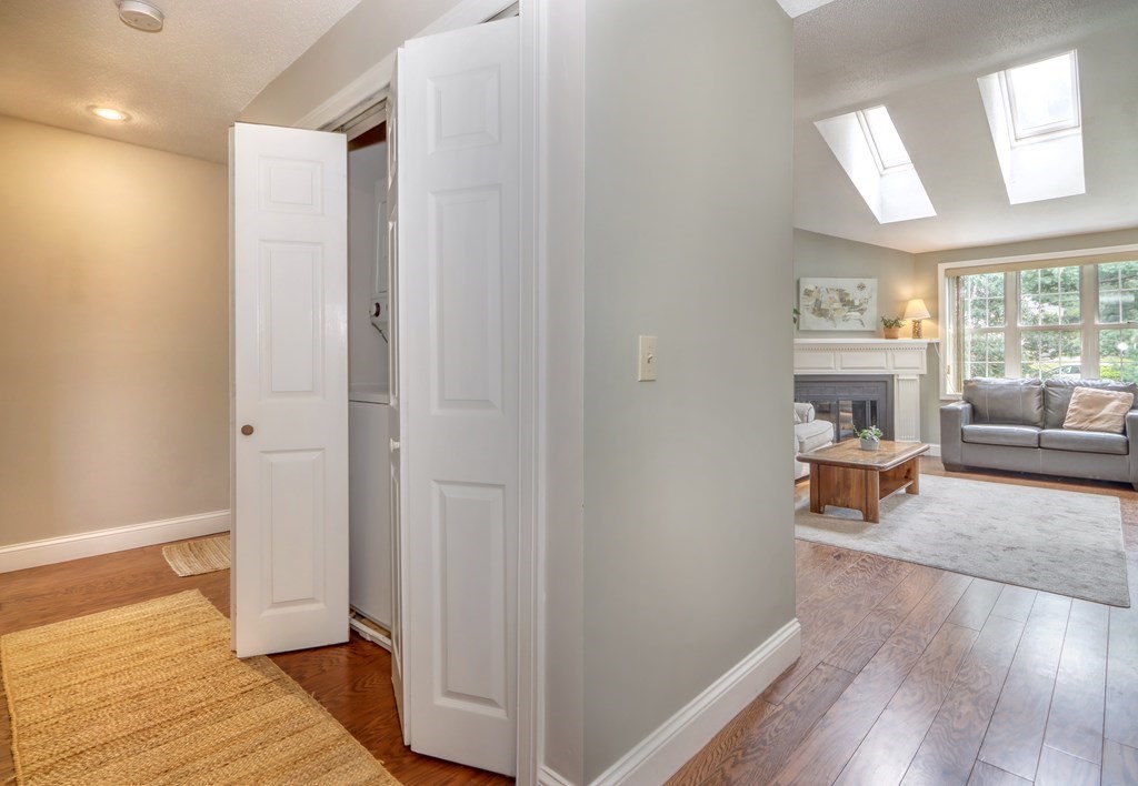 106 Shaw Farm Road, Unit 106 Canton, MA 02021 - Photo 11 of 27 a view of a livingroom and a hall with wooden floor