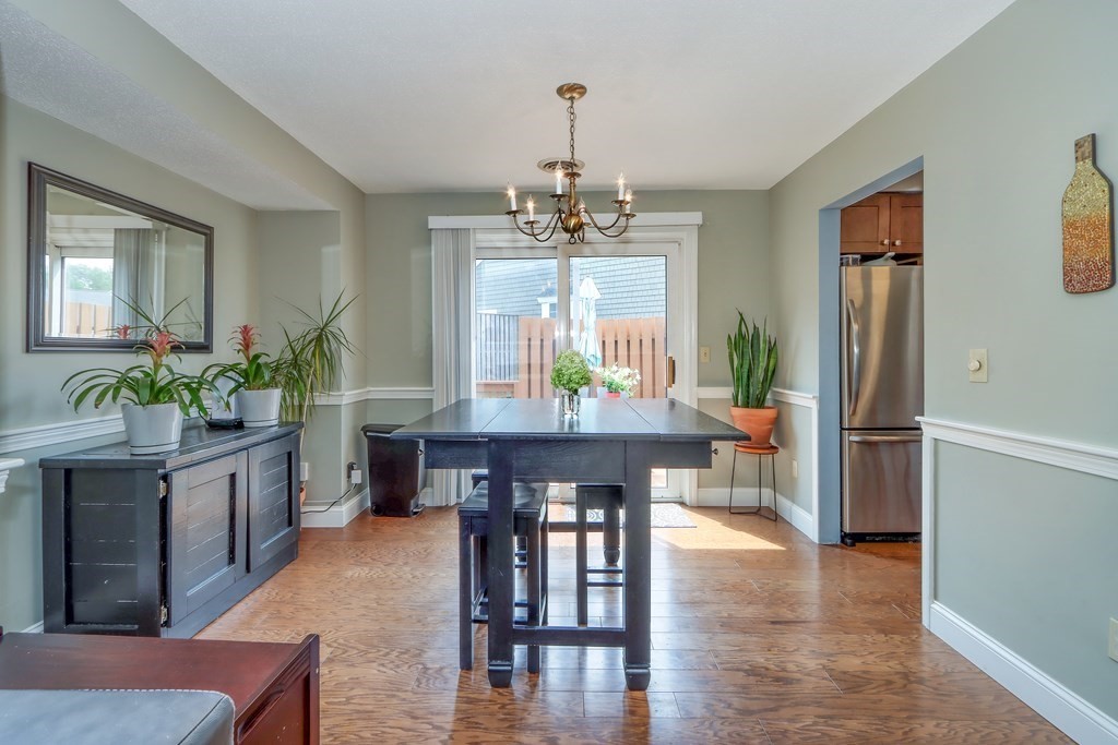 106 Shaw Farm Road, Unit 106 Canton, MA 02021 - Photo 12 of 27 a dining room with furniture a chandelier and wooden floor