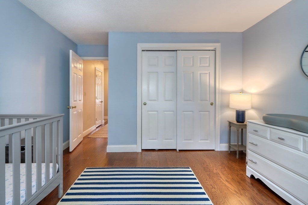106 Shaw Farm Road, Unit 106 Canton, MA 02021 - Photo 19 of 27 a view of a hallway with wooden floor and cabinet