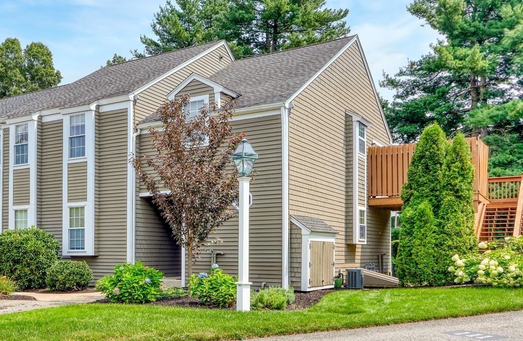 106 Shaw Farm Road, Unit 106 Canton, MA 02021 - Photo 27 of 27 a view of a house with a yard and plants