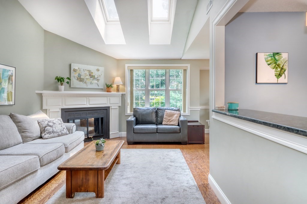 106 Shaw Farm Road, Unit 106 Canton, MA 02021 - Photo 4 of 27 a living room with furniture and a fireplace