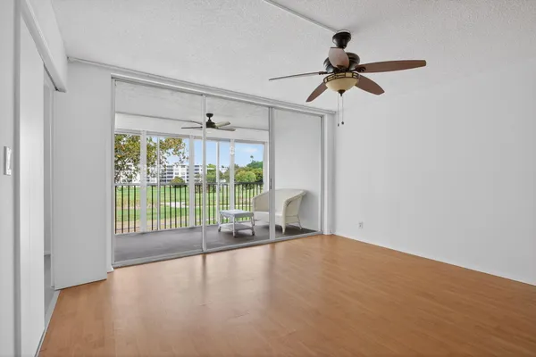 a view of a room with wooden floor and balcony