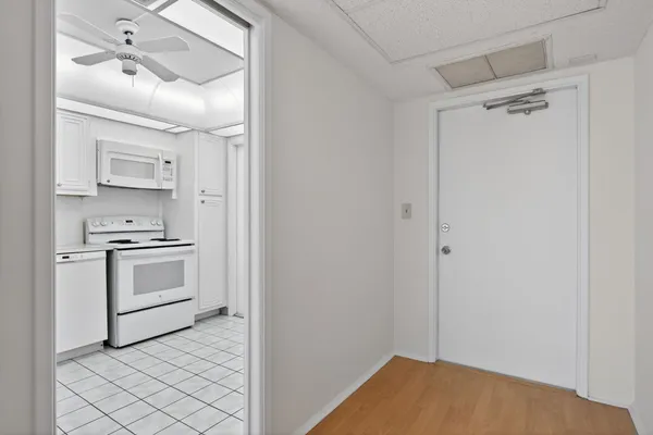 a view of kitchen with sink cabinet and refrigerator