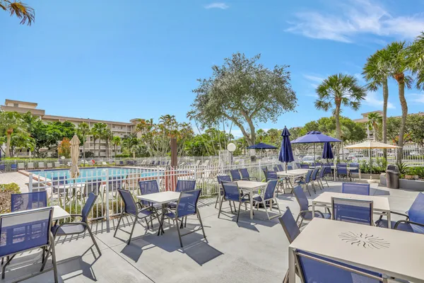 a view of a swimming pool with a lawn chairs