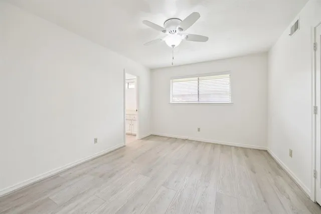a spacious bathroom with a granite countertop sink and a mirror