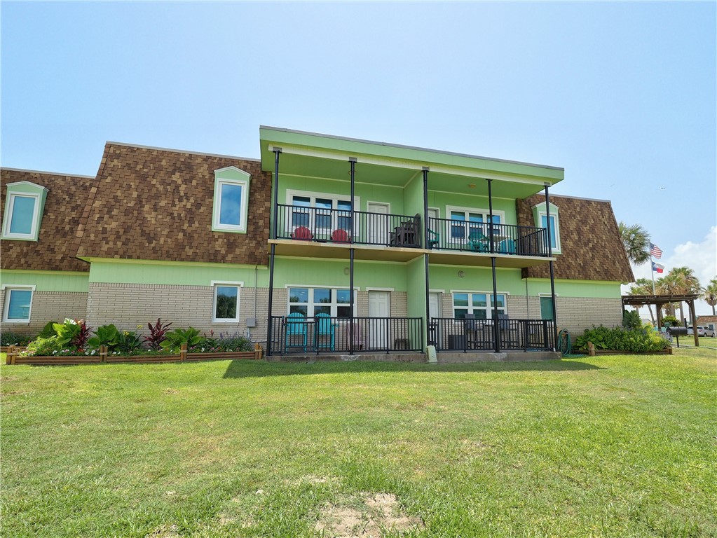 700 Island Retreat Road, Unit 37 Port Aransas, TX 78373 - Photo 1 of 34 a view of a cafe with table and chairs