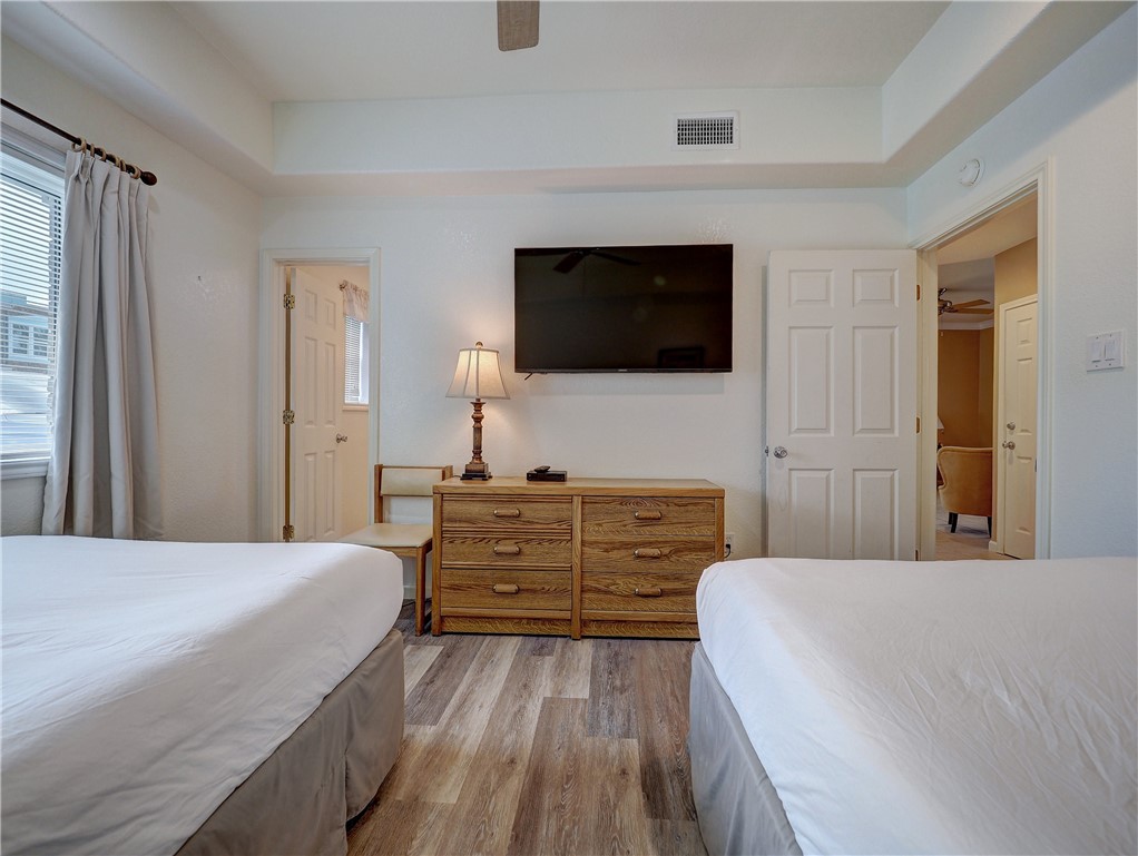 700 Island Retreat Road, Unit 37 Port Aransas, TX 78373 - Photo 13 of 34 a bedroom with a bed and a flat screen tv