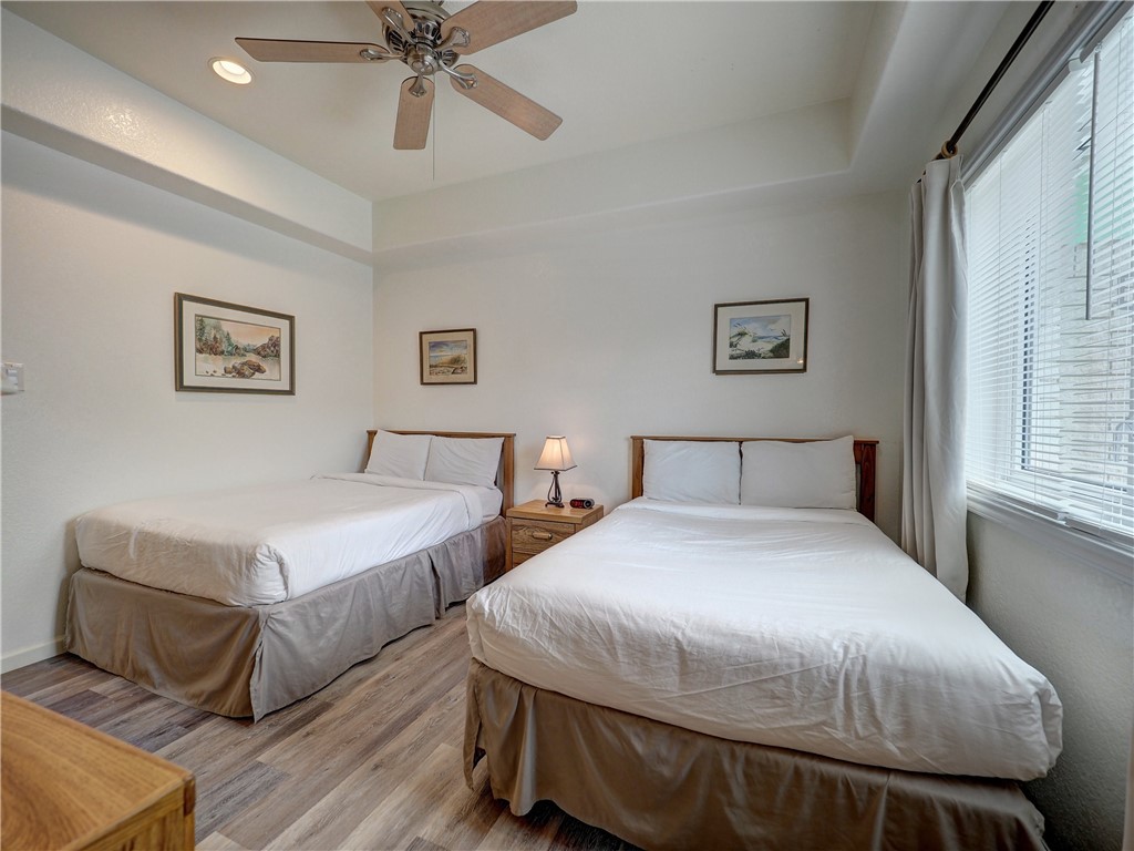 700 Island Retreat Road, Unit 37 Port Aransas, TX 78373 - Photo 14 of 34 a bedroom with two beds and painting on the wall
