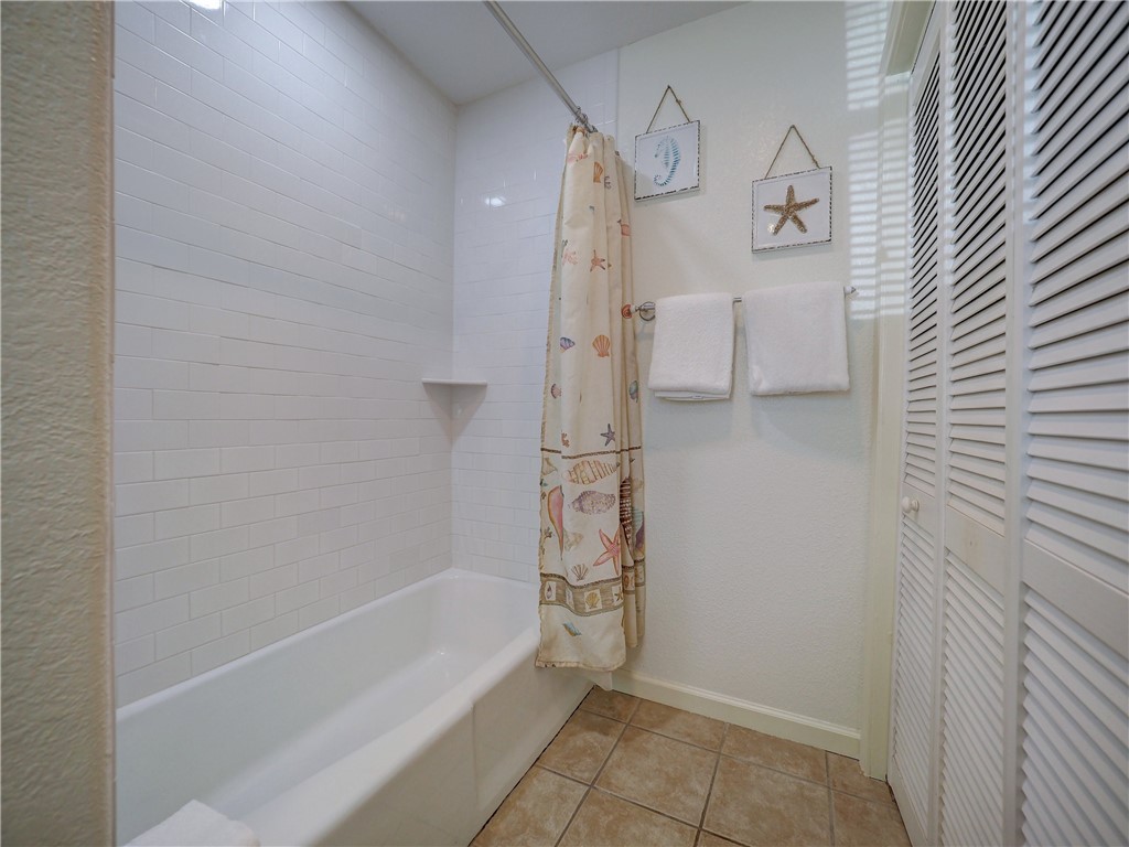 700 Island Retreat Road, Unit 37 Port Aransas, TX 78373 - Photo 17 of 34 a bathroom with a bathtub and a shower