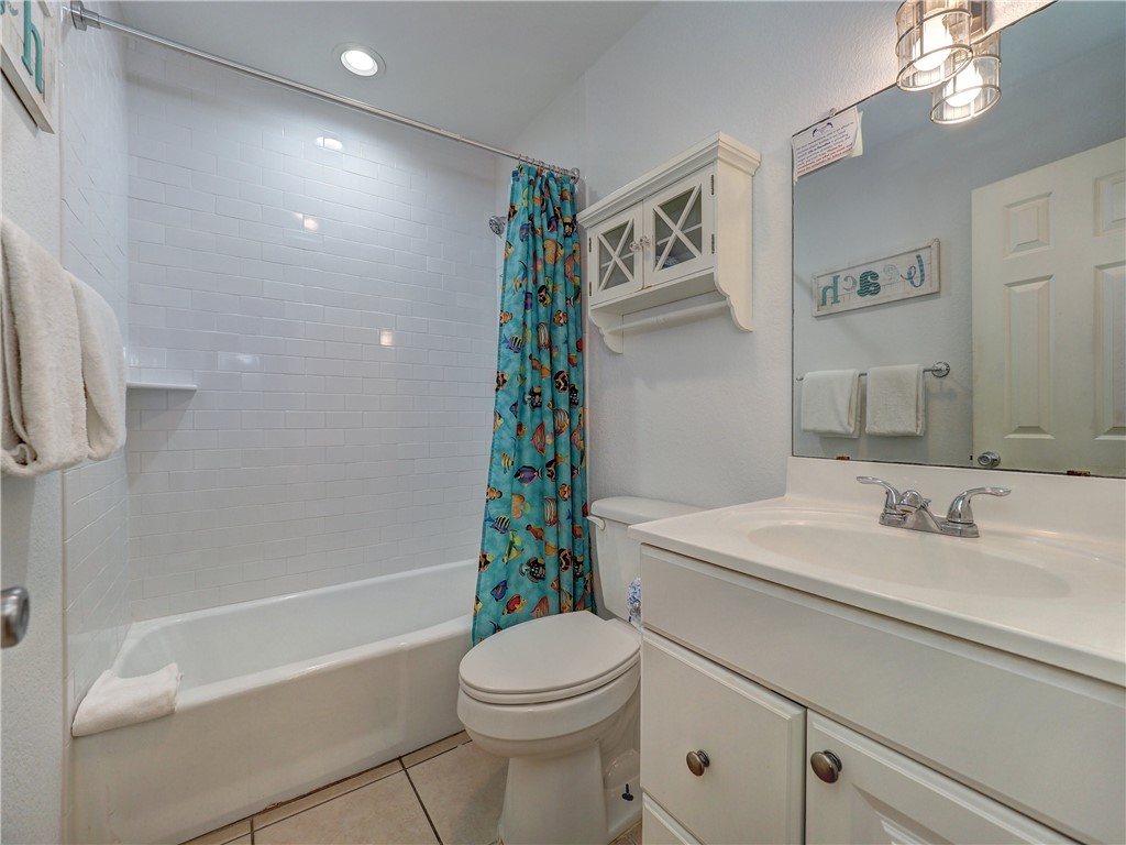700 Island Retreat Road, Unit 37 Port Aransas, TX 78373 - Photo 20 of 34 a bathroom with a sink a toilet and shower