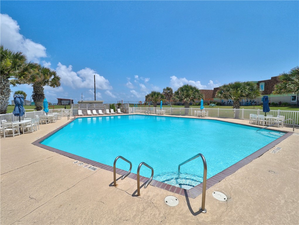 700 Island Retreat Road, Unit 37 Port Aransas, TX 78373 - Photo 25 of 34 a view of swimming pool with outdoor seating and a garden
