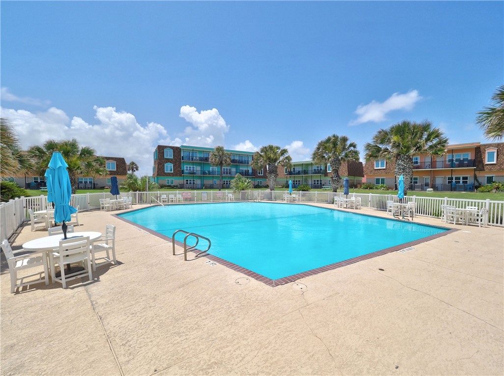 700 Island Retreat Road, Unit 37 Port Aransas, TX 78373 - Photo 26 of 34 a view of a swimming pool and lounge chairs
