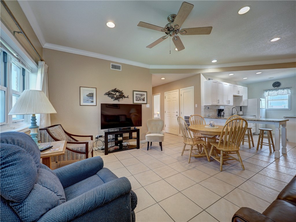 700 Island Retreat Road, Unit 37 Port Aransas, TX 78373 - Photo 5 of 34 a living room with furniture and a flat screen tv with kitchen view