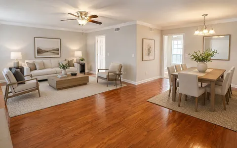 a living room with fireplace furniture and a wooden floor