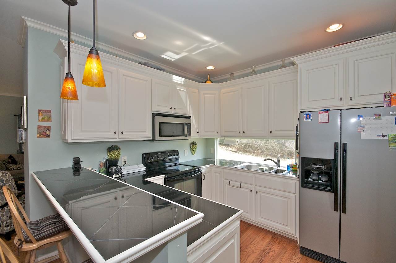 54 Jonestown Road Fairfield, VA 24435 - Photo 7 of 29 a kitchen with stainless steel appliances granite countertop a refrigerator a sink dishwasher a stove and white cabinets with wooden floor