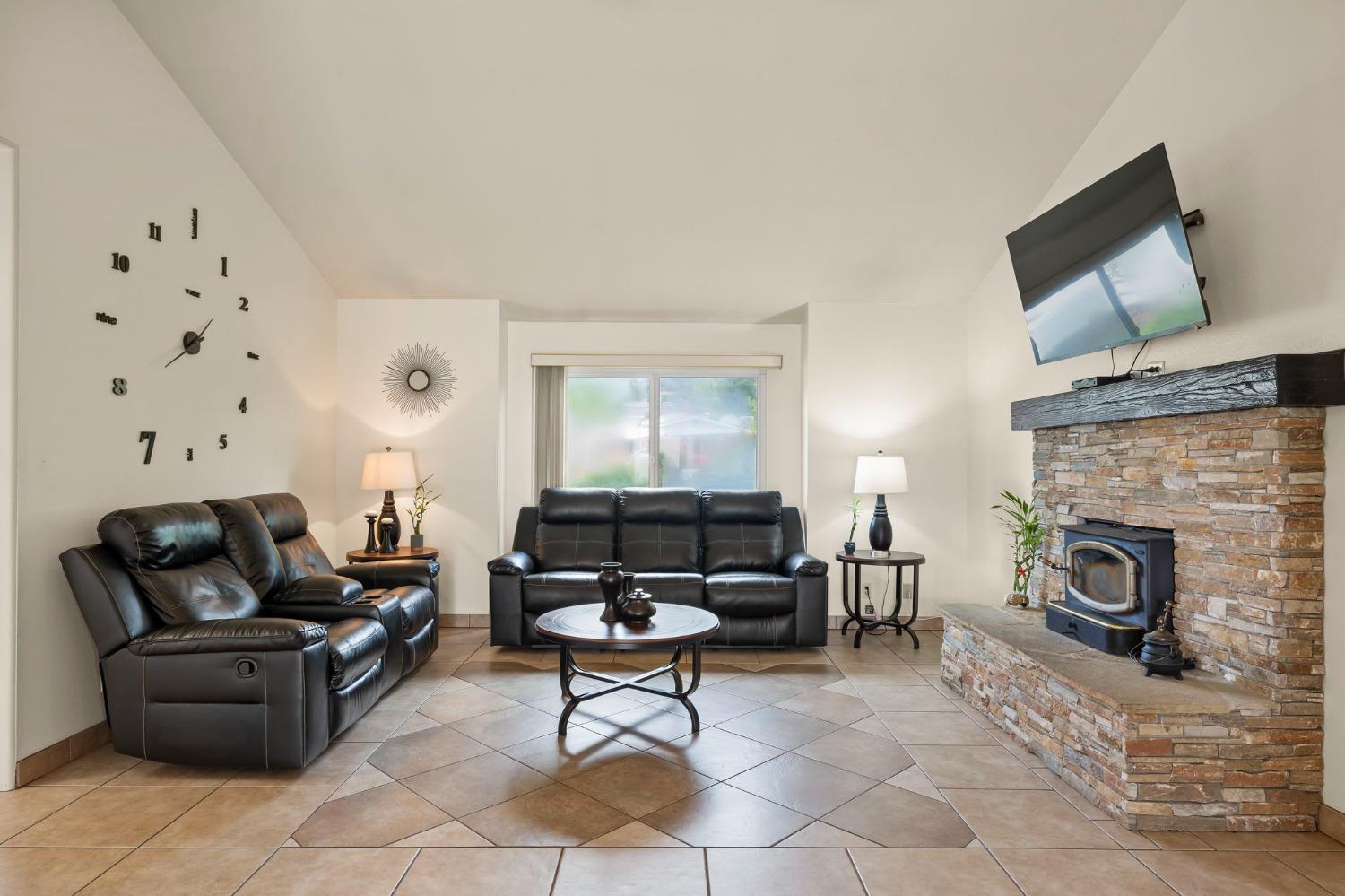 150 North Donna Street Oak View, CA 93022 - Photo 11 of 47 a living room with furniture a flat screen tv and a fireplace