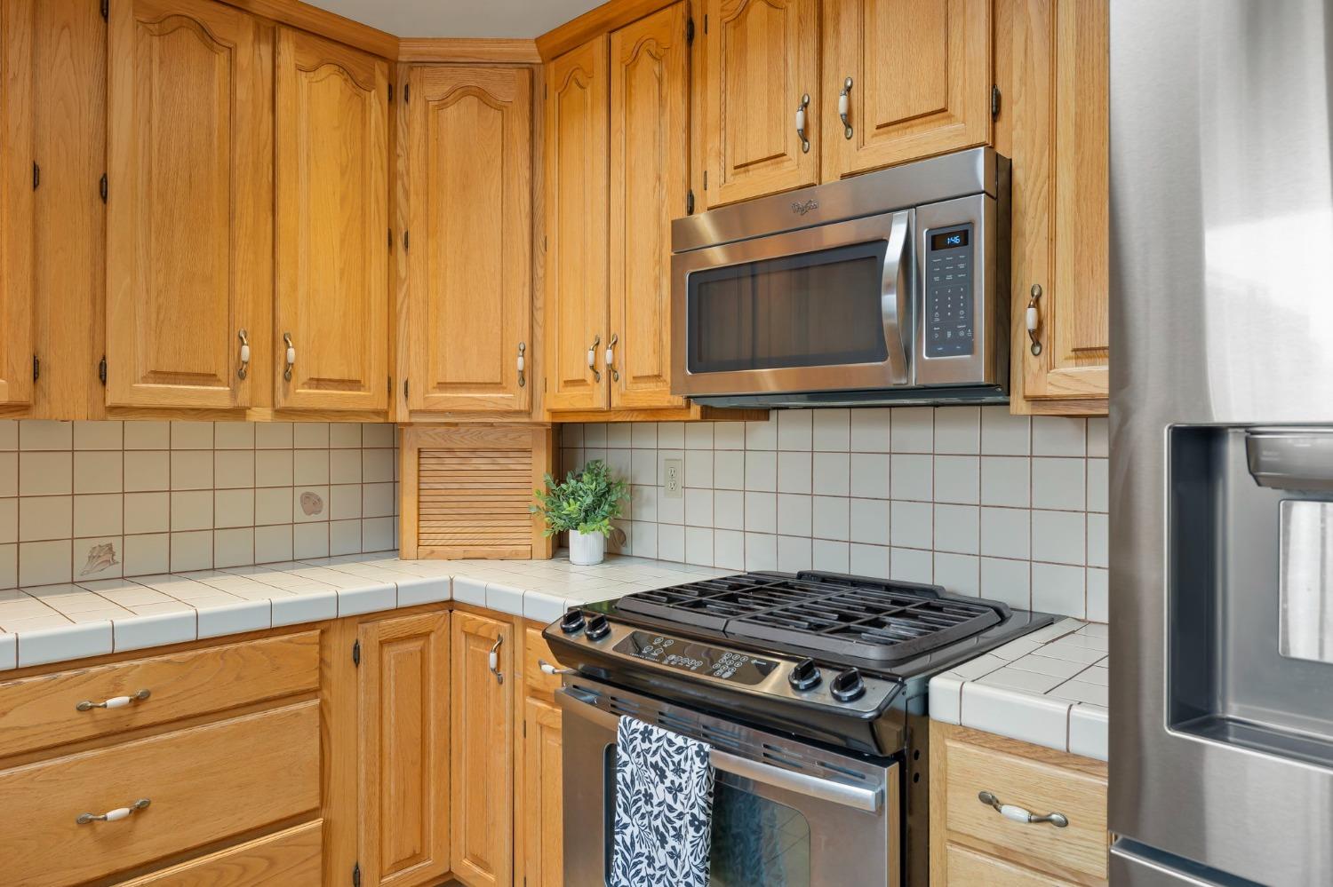 150 North Donna Street Oak View, CA 93022 - Photo 18 of 47 a kitchen with granite countertop cabinets stainless steel appliances and a counter space