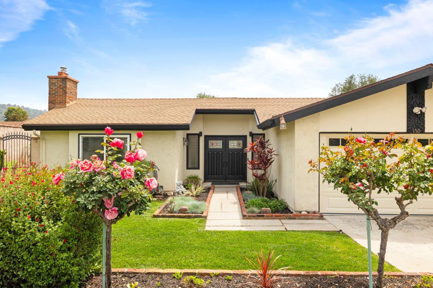 150 North Donna Street Oak View, CA 93022 - Photo 3 of 47 a front view of a house with a yard and potted plants