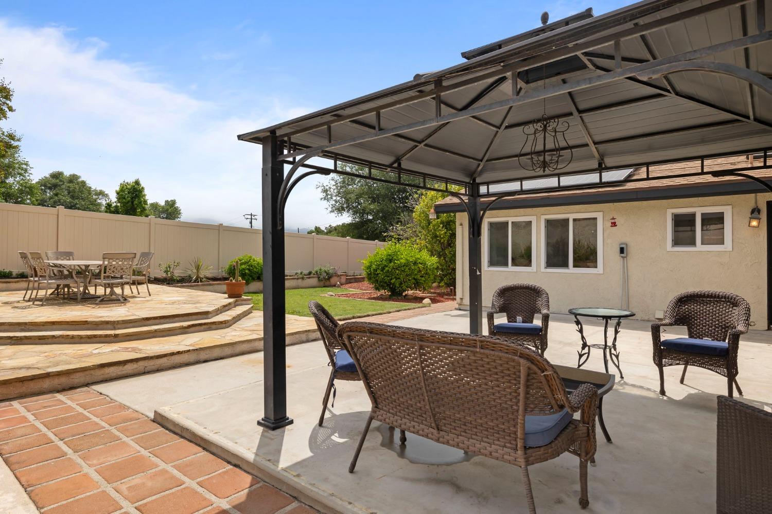 150 North Donna Street Oak View, CA 93022 - Photo 32 of 47 a view of a patio with table and chairs under an umbrella