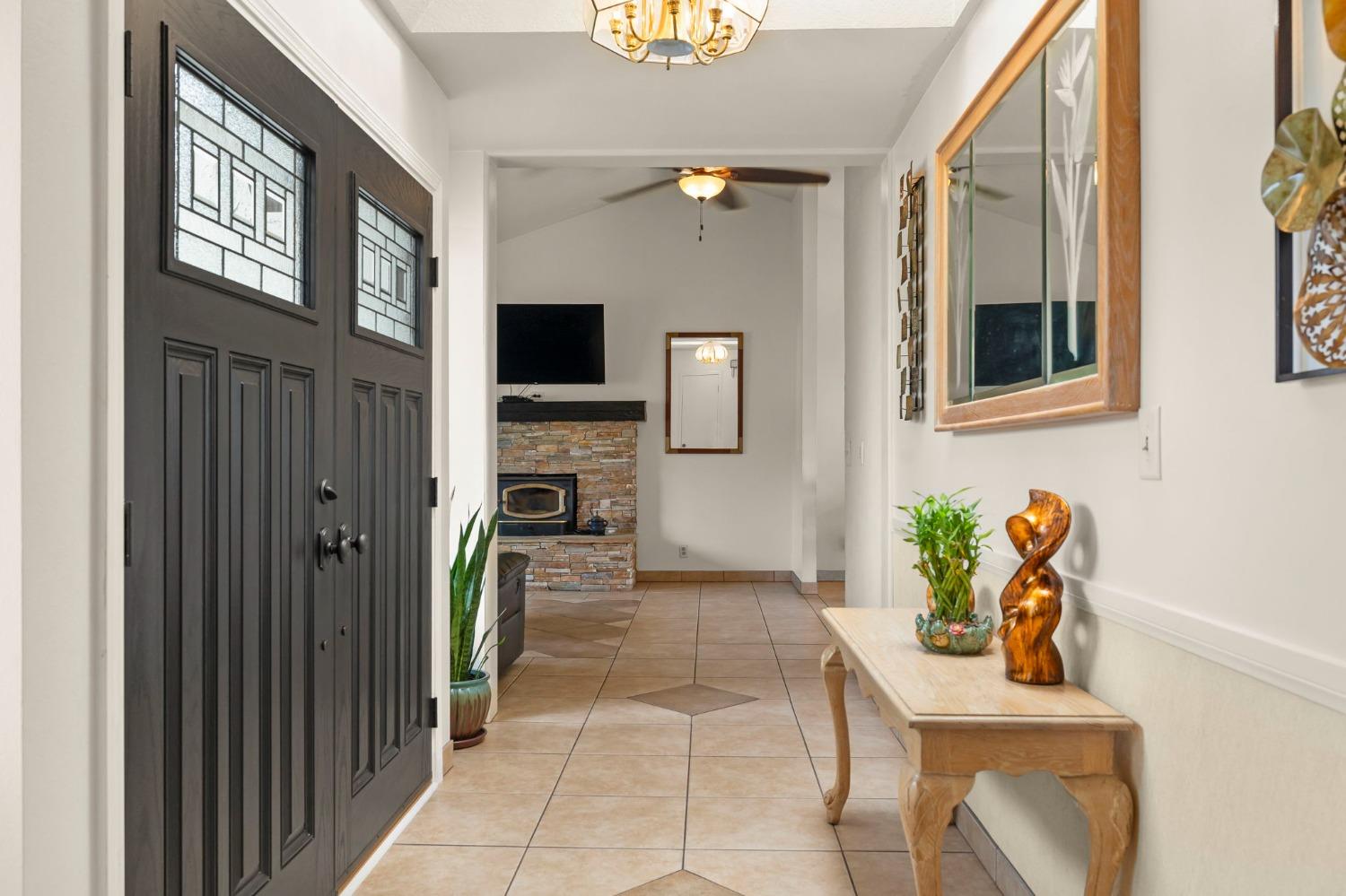 150 North Donna Street Oak View, CA 93022 - Photo 9 of 47 a hallway with a potted plant on the wall and a flat screen tv