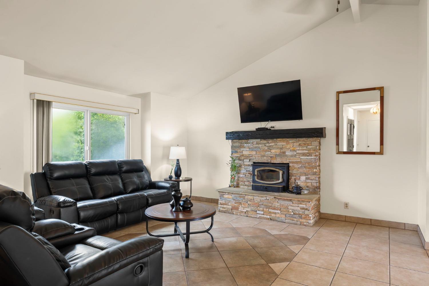 150 North Donna Street Oak View, CA 93022 - Photo 10 of 47 a living room with furniture a flat screen tv and a fireplace