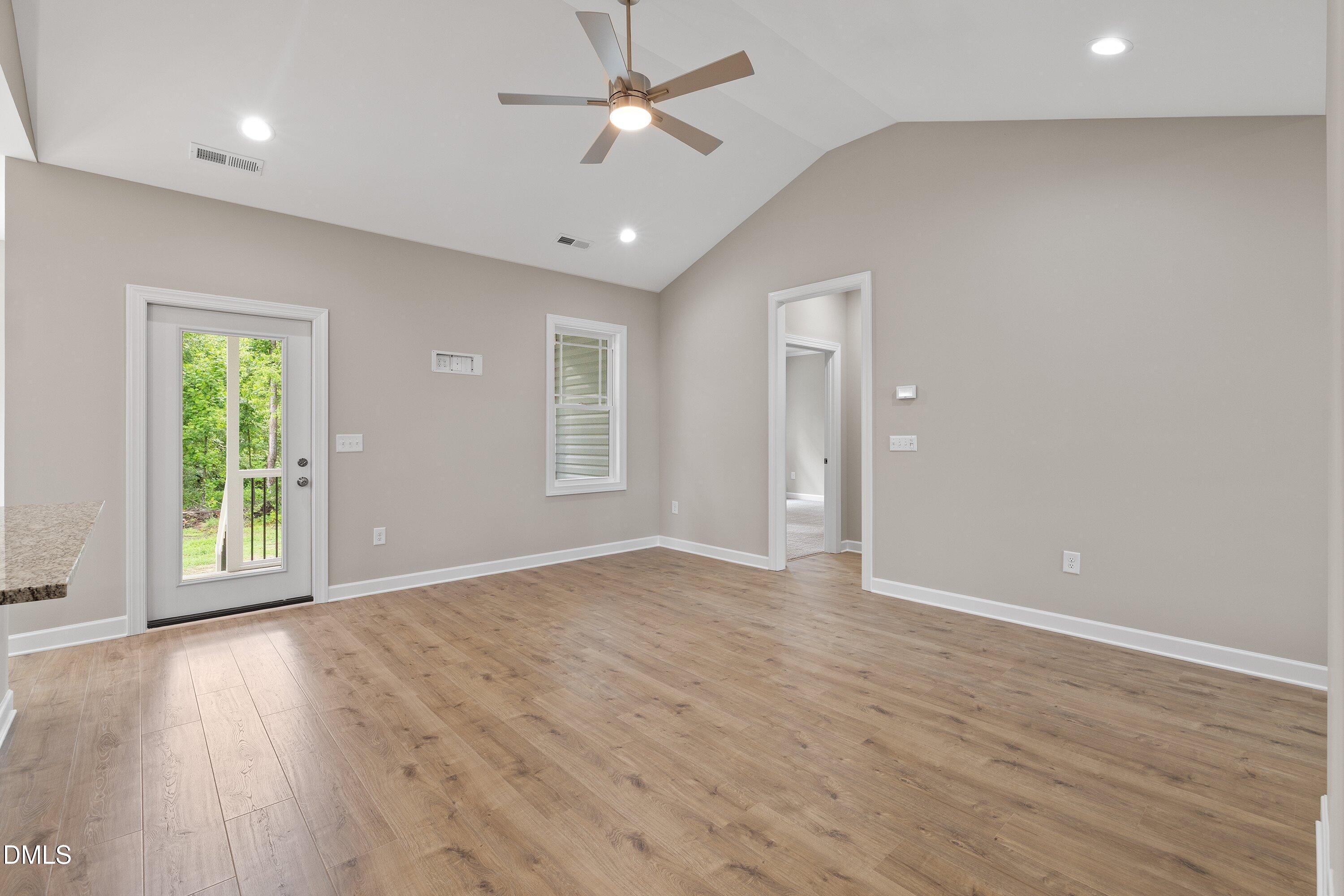 1115 Nor-Am Road Pikeville, NC 27863 - Photo 13 of 40 an empty room with wooden floor and windows