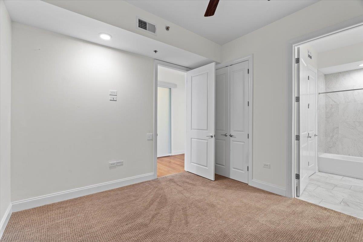 717 Riverside Drive, Unit 906 Memphis, TN 38103 - Photo 13 of 24 Unfurnished bedroom featuring carpet, ensuite bath, visible vents, recessed lighting, and baseboards