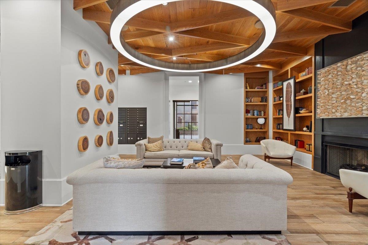 717 Riverside Drive, Unit 906 Memphis, TN 38103 - Photo 23 of 24 Living area featuring beamed ceiling, built in shelves, wooden ceiling, and wood finished floors
