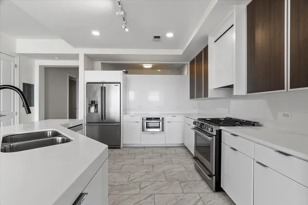 a kitchen with a stove and a refrigerator