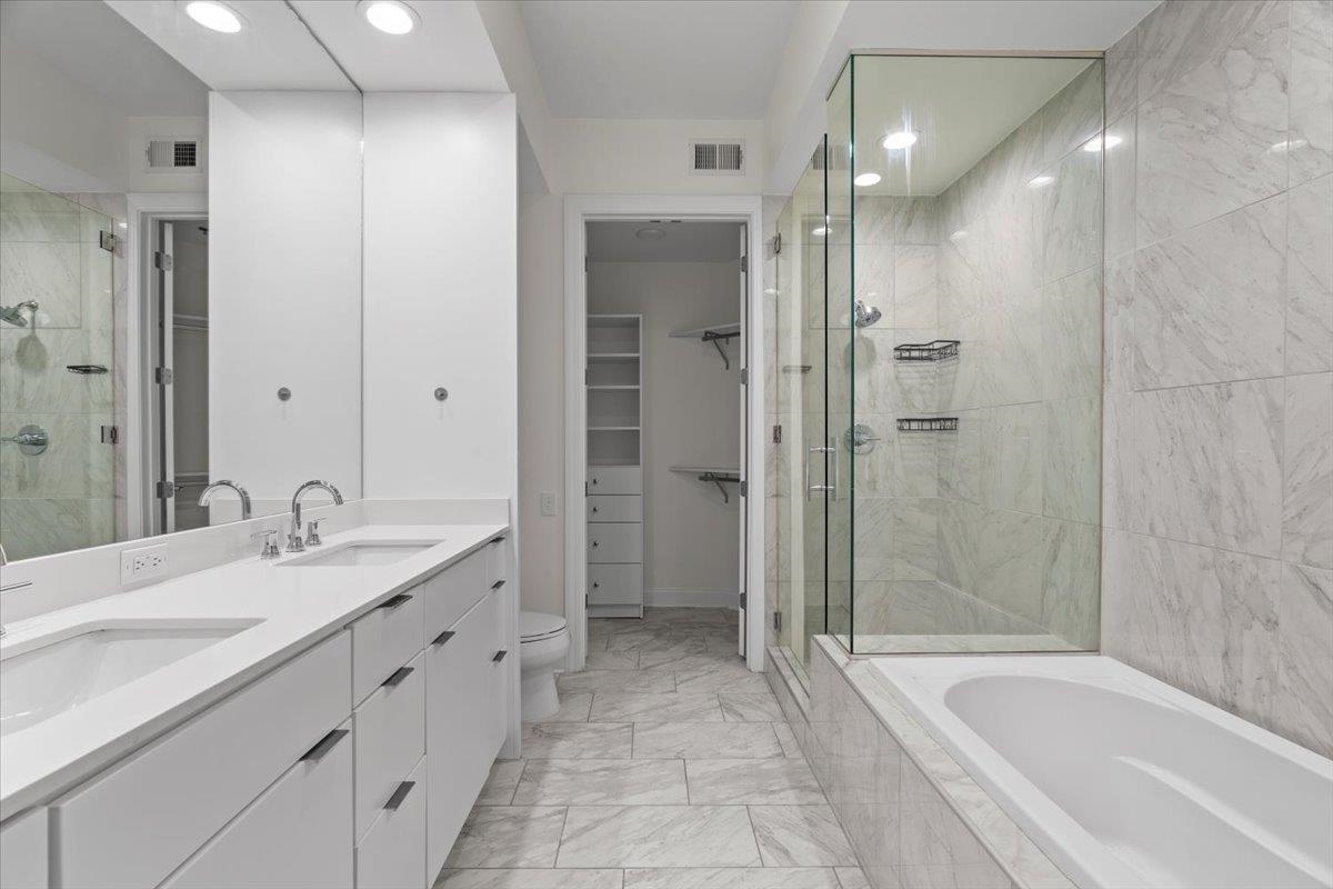 717 Riverside Drive, Unit 906 Memphis, TN 38103 - Photo 10 of 24 Bathroom with visible vents, marble finish floor, and a stall shower