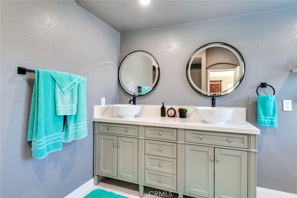 20885 Bakal Drive Riverside, CA 92508 - Photo 21 of 47 a bathroom with a granite countertop sink and a mirror