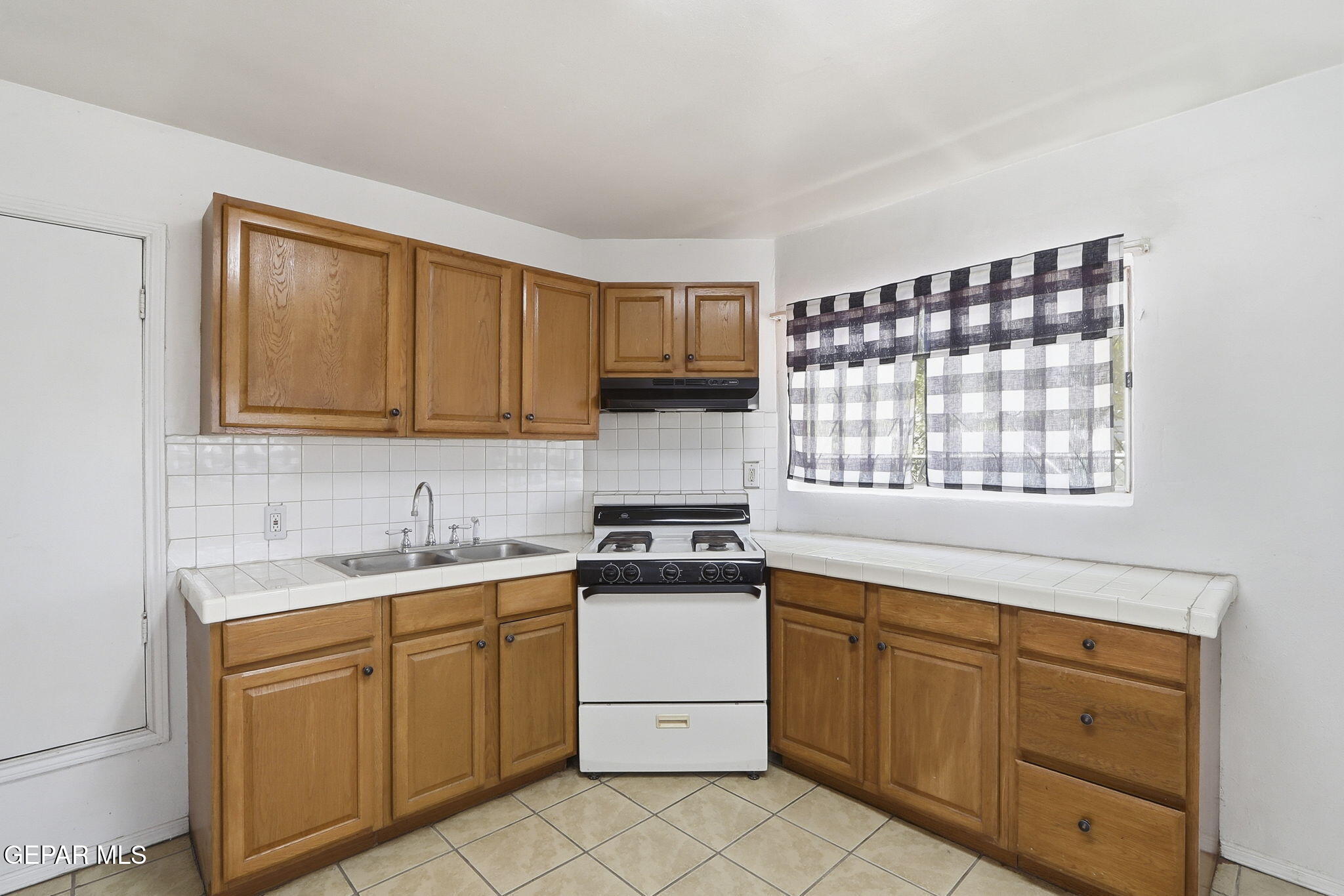 496 Telop Road El Paso, TX 79927 - Photo 12 of 12 a kitchen with granite countertop cabinets stainless steel appliances a sink and a window