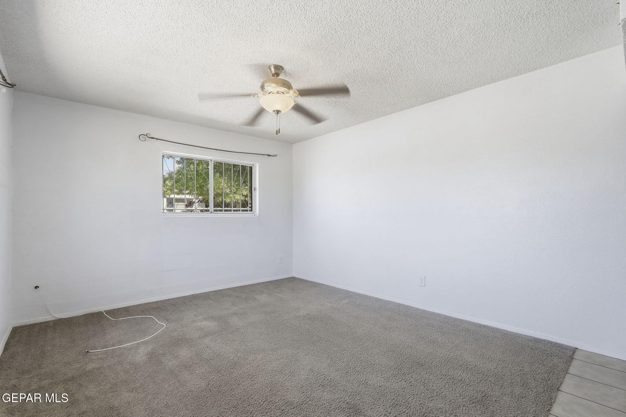 496 Telop Road El Paso, TX 79927 - Photo 3 of 12 an empty room with windows and fan