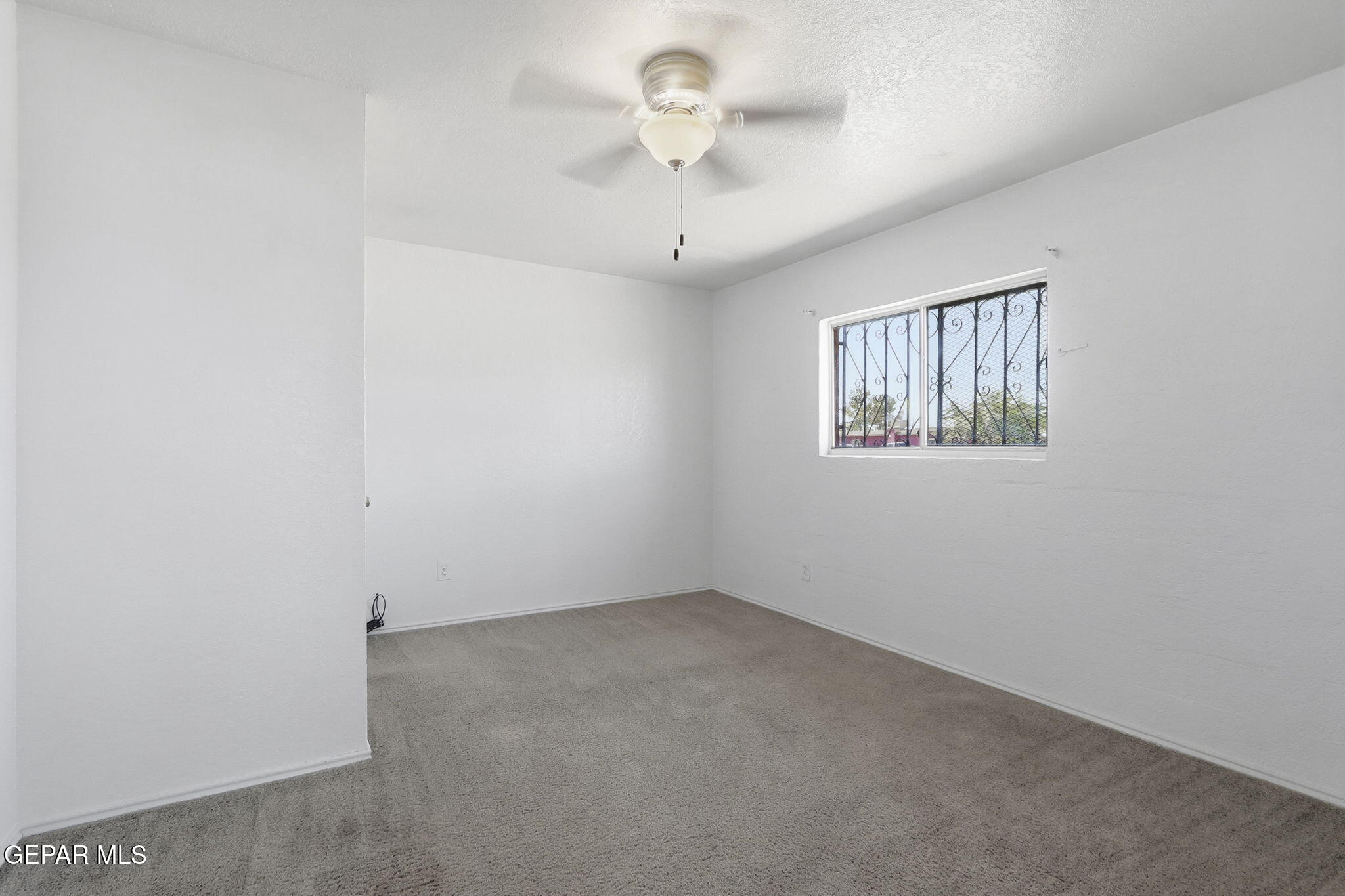 496 Telop Road El Paso, TX 79927 - Photo 4 of 12 a view of empty room with windows