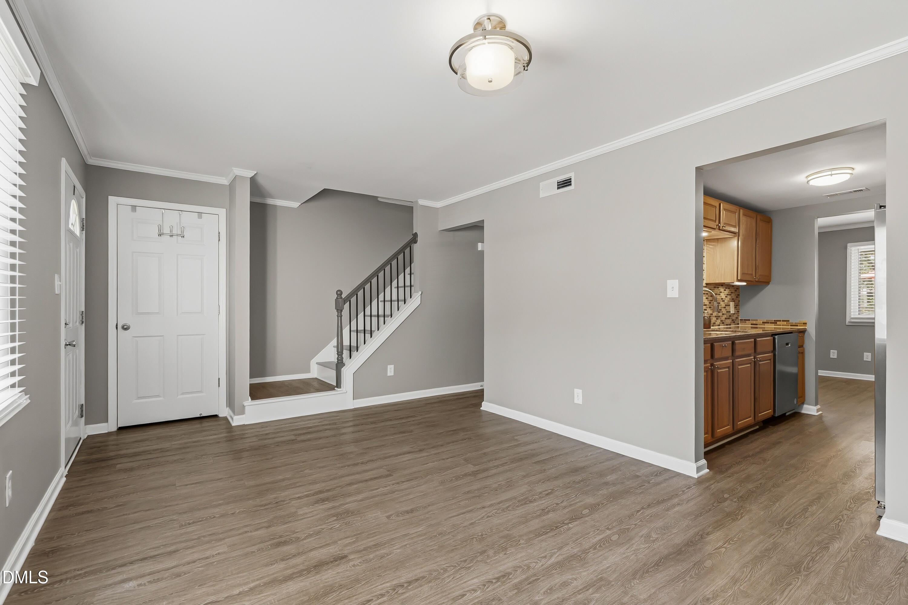 7715 Ohmann Court Raleigh, NC 27615 - Photo 14 of 36 Living Room into Kitchen